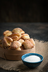 Homemade cookies with cottage cheese in a rustic bowl on a dark background.