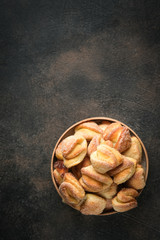 Homemade cookies with cottage cheese in a rustic bowl on a dark background top view free copy space.