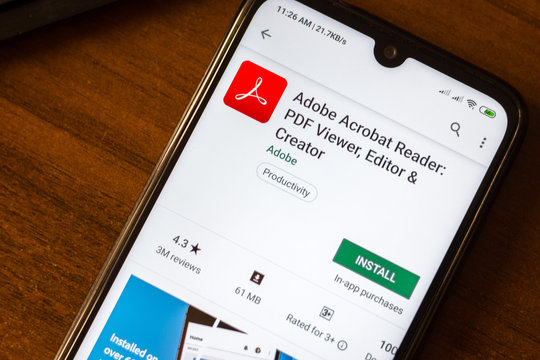 Ivanovsk, Russia - June 26, 2019: Adobe Acrobat Reader app on the display of smartphone.