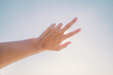 Hand of a man reaching to towards sky. Hand make symbol.