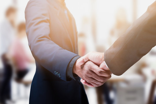 Negotiating business, Business people shaking hands in the office, Handshake gesturing people connection deal concept. - Image