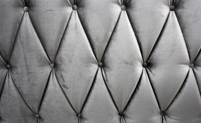 Naklejka premium Back of the sofa photo at close range. The upholstery of the sofa of shimmering velour with drawstring and pleats.