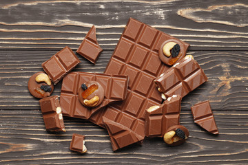 Milk chocolate different pieces and a bar close-up. Top view. Place for text.