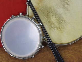 Close-up of two Brazilian percussion musical instruments: &ldquo;tamborim&rdquo; with drumstick  and "pandeiro" (tambourine). The instruments are widely used to accompany samba, a popular Brazilian rhythm.