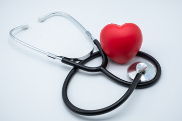 Red heart and medical stethoscope. Close up. Placed on the table with space to put text. Heart health concept Health insurance. World health day. Human health that needs to be examined and treated.