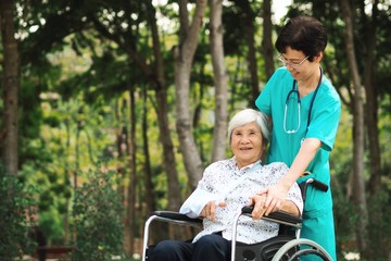 Nurse and elderly woman in the park 