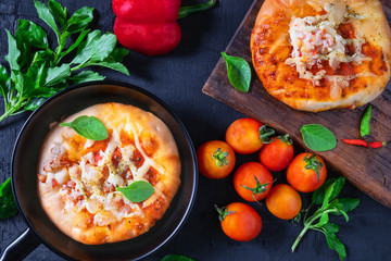 .Pizza in a pan with pizza on a wooden tray