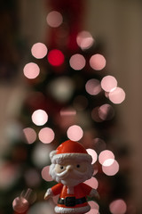 Baby Santa Claus with light-bokeh in the background