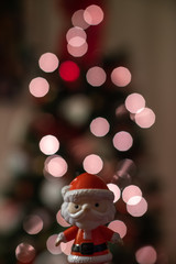 Baby Santa Claus with light-bokeh in the background