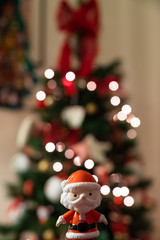 Baby Santa Claus with light-bokeh in the background