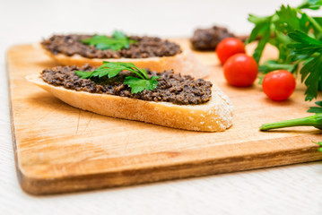 Fresh tasty bruschetta with truffle sauce, parsley and tomates