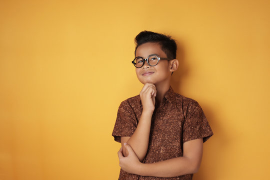 Asian Boy Looking Up And Thinking