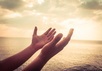 A man praying hand for blessings When the sun goes down Hope for a happy life