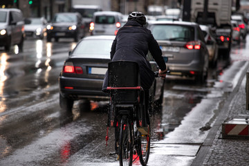 bicyclist on a rainy city winter street