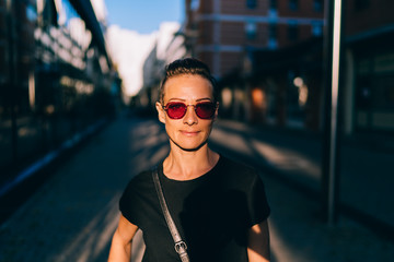 Portrait of woman standing in the street at sunset