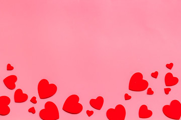 Valentine's Day design. Red hearts frame on pink background top-down copy space