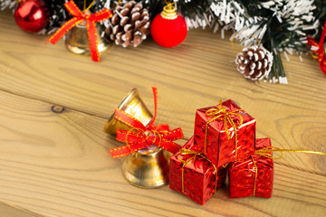 Fototapeta na wymiar Christmas Decoration, Gifts tree branches and bells on wooden boards