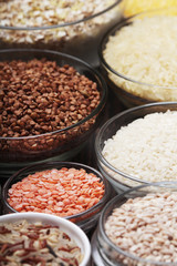 A set of bowls filled with different seeds: buckwheat, rise, corn and oatmeal	