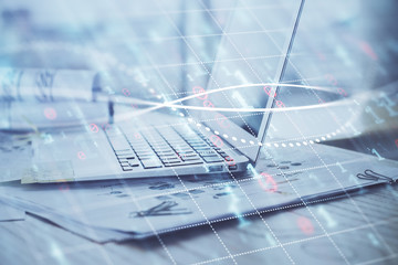 Forex Chart hologram on table with computer background. Multi exposure. Concept of financial markets.