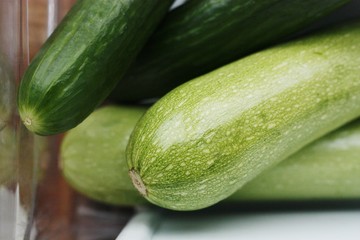 Fresh cucumbers and zucchini on the table