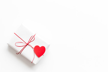 Valentine's Day gift. Present box near paper hearts on white background top-down copy space