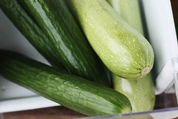 Fresh cucumbers and zucchini on the table