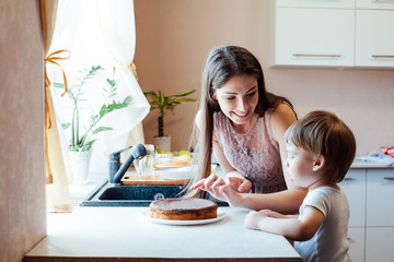 mother and son eating pie in the kitchen