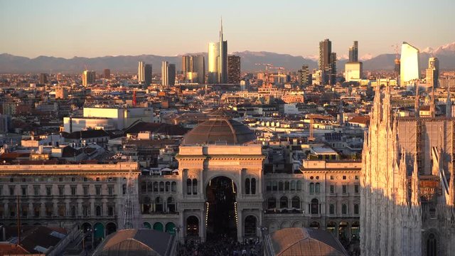 Italy , Milan december 13,2019 - Amzing view of the downtown of the city from Terrazza Martini rooftop during the sunset - Duomo cathedral , Vittorio Emanuele Gallery and skyline with new skyscepers  