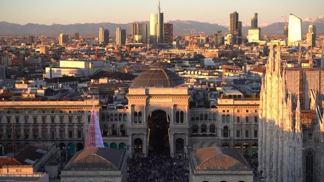 Italy , Milan december 13,2019 - Amzing view of the downtown of the city from Terrazza Martini rooftop during the sunset - Duomo cathedral , Vittorio Emanuele Gallery and skyline with new skyscepers  