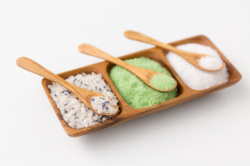 beauty, bath and wellness concept - sea salt and spoon on wooden tray