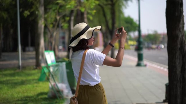 tourist asian woman walking and take a photo