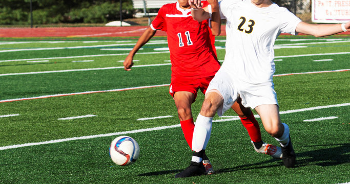 Two High School Soccer Players Fighting For The Ball