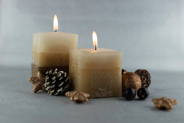 Burning candles on silver background