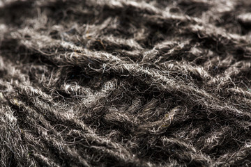 Wool yarn close-up gray threads for needlework in macro. Background texture fabric for knitting needle.