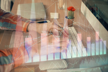 Double exposure of stock market chart with man working on computer on background. Concept of financial analysis.