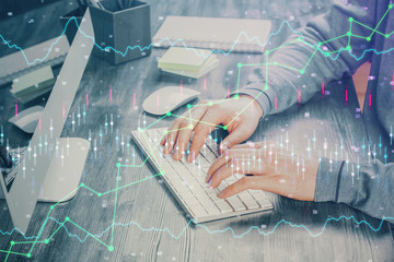 Double exposure of financial graph with man works in office on background. Concept of analysis.