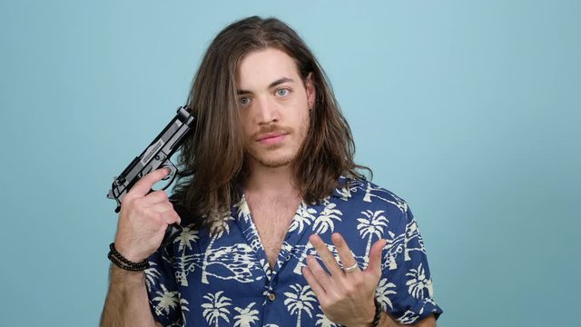guy long hair shoots himself on a blue background