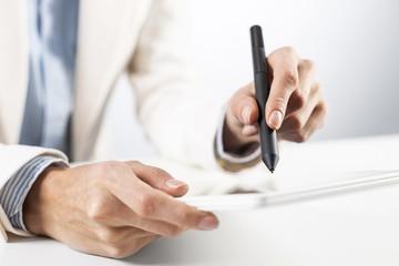 Man in business suit using tablet computer.