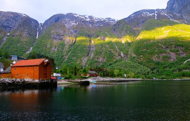 Wooden dock house in an Eidfjord, Norway.Mountain background.