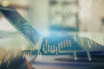 Forex graph hologram on table with computer background. Double exposure. Concept of financial markets.