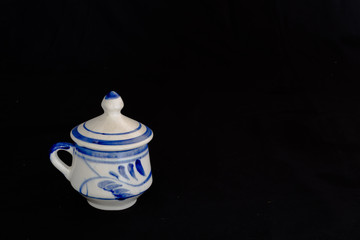 A closed Talavera vase with an elegant black background