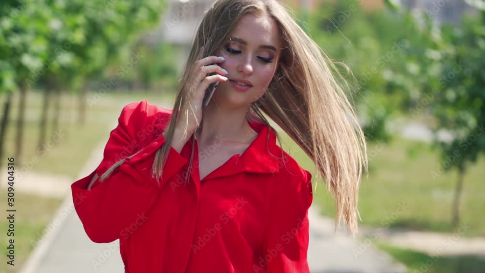 Poster Beautiful woman talking on phone. Happy woman calling with cell telephone outside