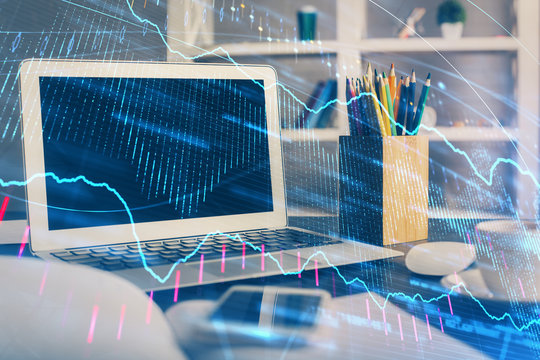 Financial graph colorful drawing and table with computer on background. Double exposure. Concept of international markets.