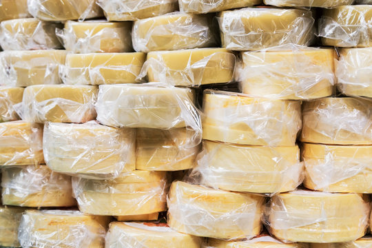 many packages of cheese are on the counter of the store. background of cheese