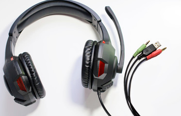 Big headphones with a microphone and wires on a white background