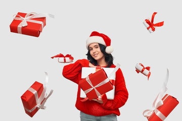 Brunette girl in a red sweater and Santa Claus hat holding white giftbox with red ribbon