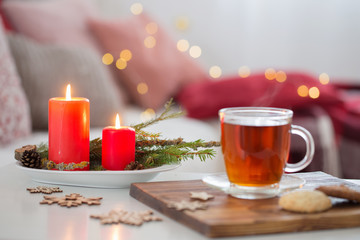 cup of tea with burning candles at home