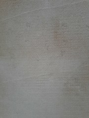  close-up of a decorative wall, with bokeh effect and characteristic rough porous texture, abstract dark and light stains