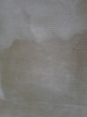 Naklejka premium close-up of a decorative wall, with bokeh effect and characteristic rough porous texture, abstract dark and light stains