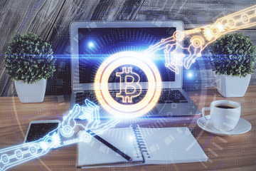 Multi exposure of blockchain theme hologram and table with computer background. Concept of bitcoin crypto currency.